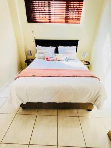 a bedroom with a large bed in a room at Luba Suite in Durban