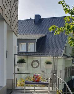 a house with a bench in front of a house at Ferienwohnung Pees in Baumholder