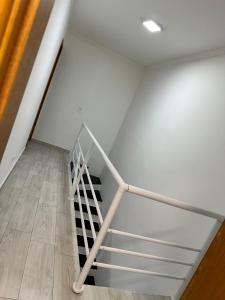 a staircase in a room with white walls and wooden floors at Hotel Aeroporto Congonhas 4 in Sao Paulo