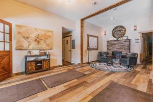 a living room with a table and chairs and a fireplace at Pintler's Portal Hostel in Anaconda +49 photos