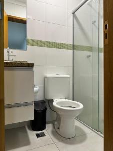 a bathroom with a toilet and a glass shower at Hotel Aeroporto Congonhas 4 in Sao Paulo