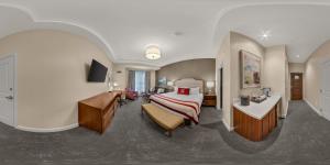 a hotel room with a bed and a desk at The Inn at Elon in Elon