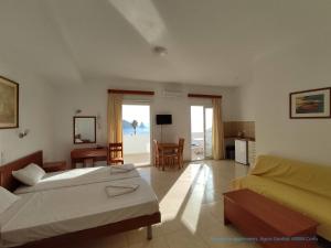 a hotel room with two beds and a living room at Panorama apartments in Agios Gordios