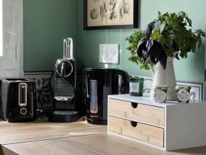 a kitchen with a table with a plant on it at * Domaine de la Solaie * - Proche Bords de Loire in Saint-Denis-de lʼHôtel