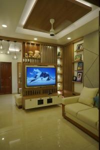 A television and/or entertainment centre at Luxury Homes - Cochin Airport - Nedumbassery