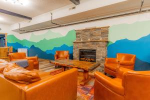 a living room with couches and a fireplace at Pintler's Portal Hostel in Anaconda