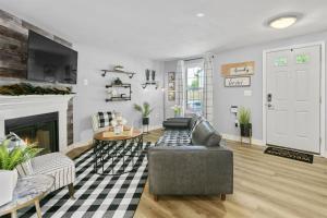 a living room with a couch and a fireplace at Luxury Sterling townhome - Private, Self checkin in Sterling