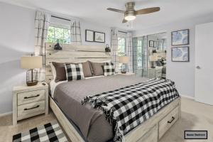 a bedroom with a bed and a ceiling fan at Luxury Sterling townhome - Private, Self checkin in Sterling