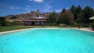 a large swimming pool in front of a house at Il Casale di Riardo Luxury B&B in Riardo