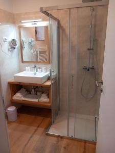 a bathroom with a sink and a shower at G House in Dutovlje