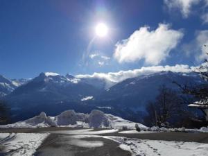 a snow covered mountain with the sun in the sky at Wohnung Rheintal im Alpenvorland in Batschuns