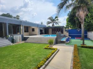 a house with a swimming pool and a yard at 17 On Buffalo in Johannesburg