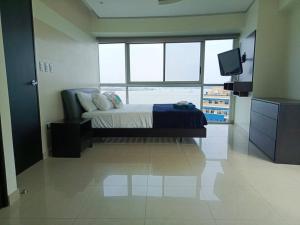 a bedroom with a bed and a television in it at Riversuits#1 Santa Ana in Guayaquil