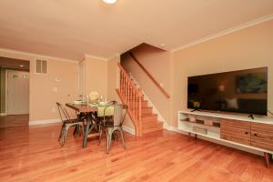 a dining room with a table and a large tv at NEW! 3-story Townhome - Private, Self checkin, Quiet. in Sterling