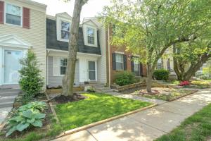 a house with trees in a yard with a sidewalk at NEW! 3-story Townhome - Private, Self checkin, Quiet. in Sterling