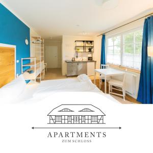 a bedroom with a bed and a desk and a kitchen at ~ Apartments zum Schloss ~ Traumhafte Ferienwohnungen auf Usedom in Mellenthin