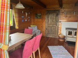 a dining room with a table and chairs in a cabin at Neuwirth Hütte in Gnesau