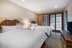 a hotel room with two beds and a television at Bluegreen Vacations Big Bear Village, Ascend Resort Collection in Big Bear Lake