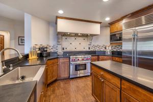 a large kitchen with wooden cabinets and stainless steel appliances at Bluegreen Vacations Big Bear Village, Ascend Resort Collection in Big Bear Lake