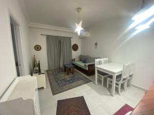 a living room with a table and a couch at One Bedroom with Balcony WI-FI Downtown Sheraton Plaza 226 in Hurghada