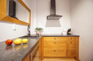 a kitchen with a sink and fruit on the counter at Warsaw Premium Apartments Deluxe Old Town in Warsaw