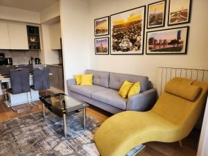 a living room with a couch and a table at Ramonda Belgrade Waterfront - BW Aqua in Belgrade
