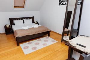 a bedroom with a bed with two towels on it at Casa Iager - Vama Buzaului 