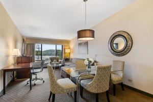 a dining room and living room with a table and chairs at Antioch Hotel & Suites in Antioch