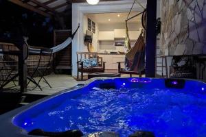 a blue hot tub in the middle of a patio at Cocon de charme avec spa, proche de la plage in Les Trois-Îlets