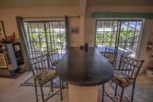 a dining room with a large table and chairs at The Campeche Town House Townhouse in South Padre Island