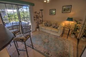 a living room with a couch and chairs and a table at The Campeche Town House Townhouse in South Padre Island