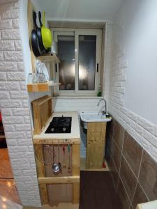 a small kitchen with a stove and a sink at First house in Brindisi