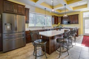 a kitchen with a large island with bar stools at Inviting Connellsville Getaway with Deck! in Connellsville