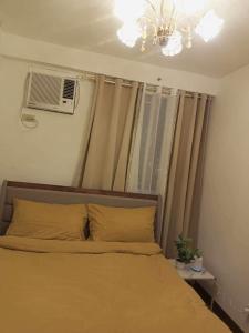 A bed or beds in a room at Arezzo Place Davao- Carol