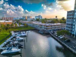 a group of boats docked in a marina in a city at Steps to the Beach Christmas Vacation Pool in Hallandale Beach