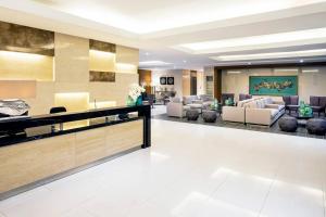a lobby with couches and chairs in a building at Breeze Residences 26th floor in Manila