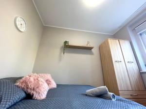 a bedroom with a bed with a stuffed animal on it at MMRent Desert Room in Gdańsk