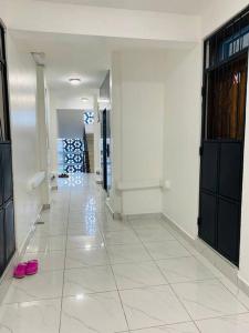 a hallway with a pair of pink shoes on the floor at Pilipili Kijani Luxury homes in Mombasa