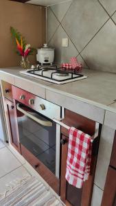 a kitchen with a stove top oven next to a counter at TIVA PERL LODGE TAHAA in Tiva