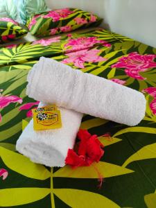 a towel animal on top of a bed at TIVA PERL LODGE TAHAA in Tiva