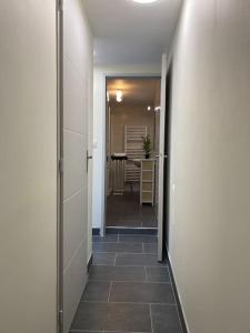 a hallway with a hallway leading to a dining room at Maison de Charme - 4 Chambres - Courette & Parking Gratuit in Amiens +47 photos