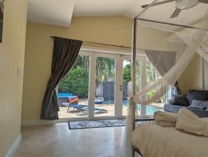 a bedroom with a bed and a sliding glass door at #1 Fort Lauderdale House - Heated Salt Water Pool - Private Oasis-Updated Gorgeous 3BR 3BA - Las Olas in Fort Lauderdale +84 photos