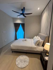 a bedroom with a bed with a ceiling fan at Eaton Residence KLCC BY Galaxy Suites in Kuala Lumpur