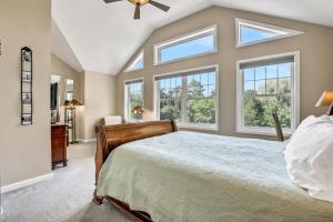 a bedroom with a large bed and windows at Moondance Ridge Suites in New Paltz