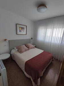 Apartamento Albejo في لاريدو: غرفة نوم بسرير كبير ونافذة