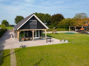 a small house with a patio and a yard at Vakantieverblijf Weidezicht in Dorst