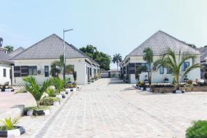 a cobblestone street in front of some houses at SILVERZB RESORT in Iseyin