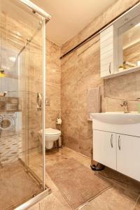 uma casa de banho com um chuveiro, um lavatório e um WC. em Prime location with terrace em Istambul