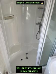a shower with a glass door in a bathroom at WILLERBY LYNDHURST in Lincolnshire