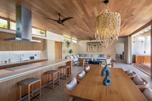 a kitchen and living room with a wooden ceiling at W Punta de Mita in Punta Mita
